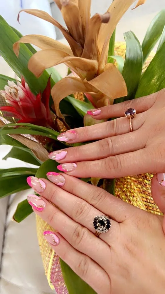 Almond nails in soft pink with gold-leaf marble accents.